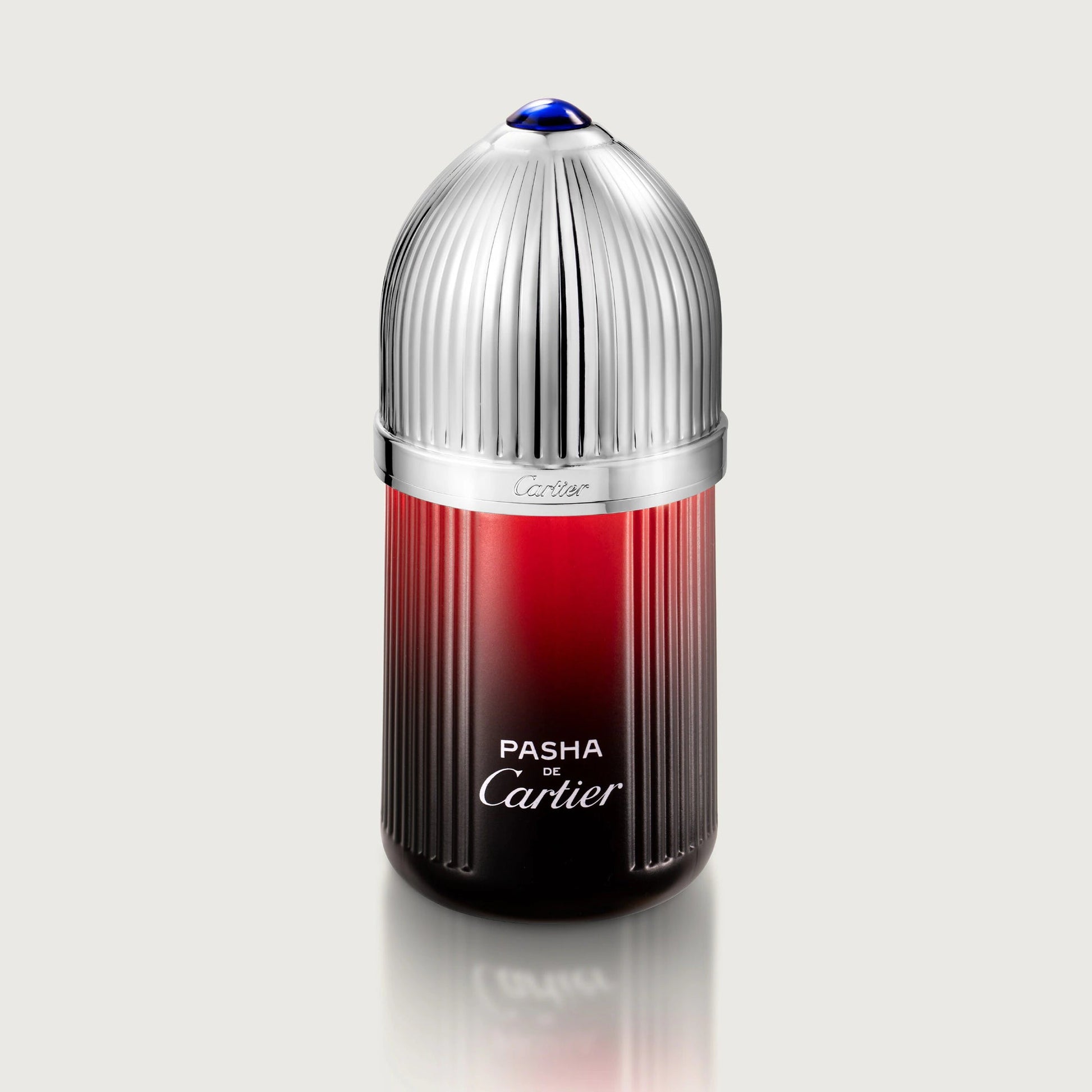 Cartier Pasha perfume bottle with red and silver design on a white background