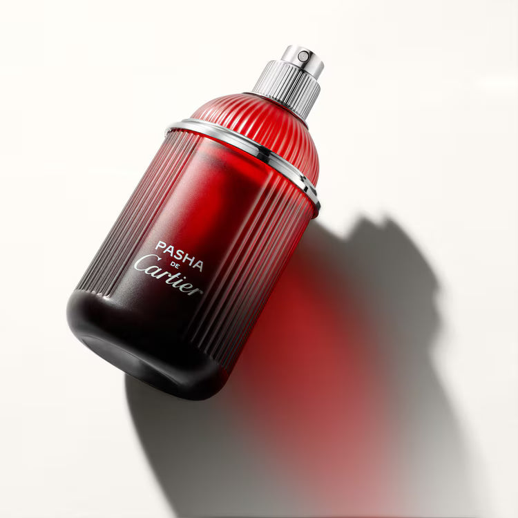 Red and black Cartier Pasha perfume bottle on a white background