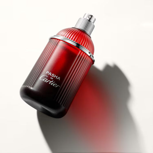 Red and black Cartier Pasha perfume bottle on a white background