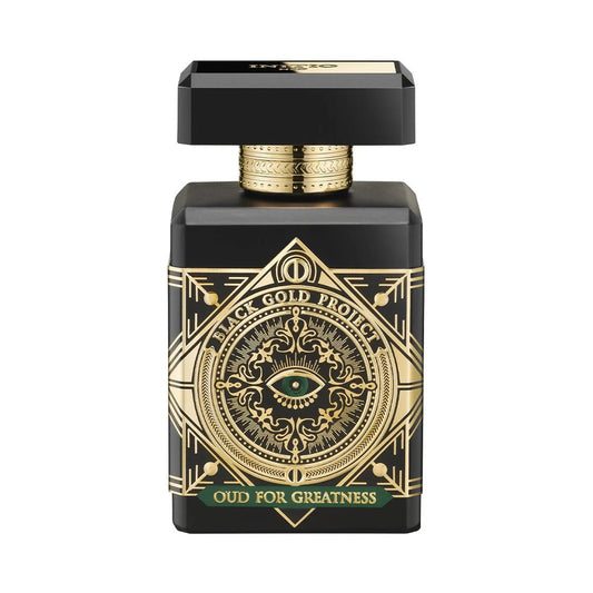 Black and gold perfume bottle with intricate design on a white background