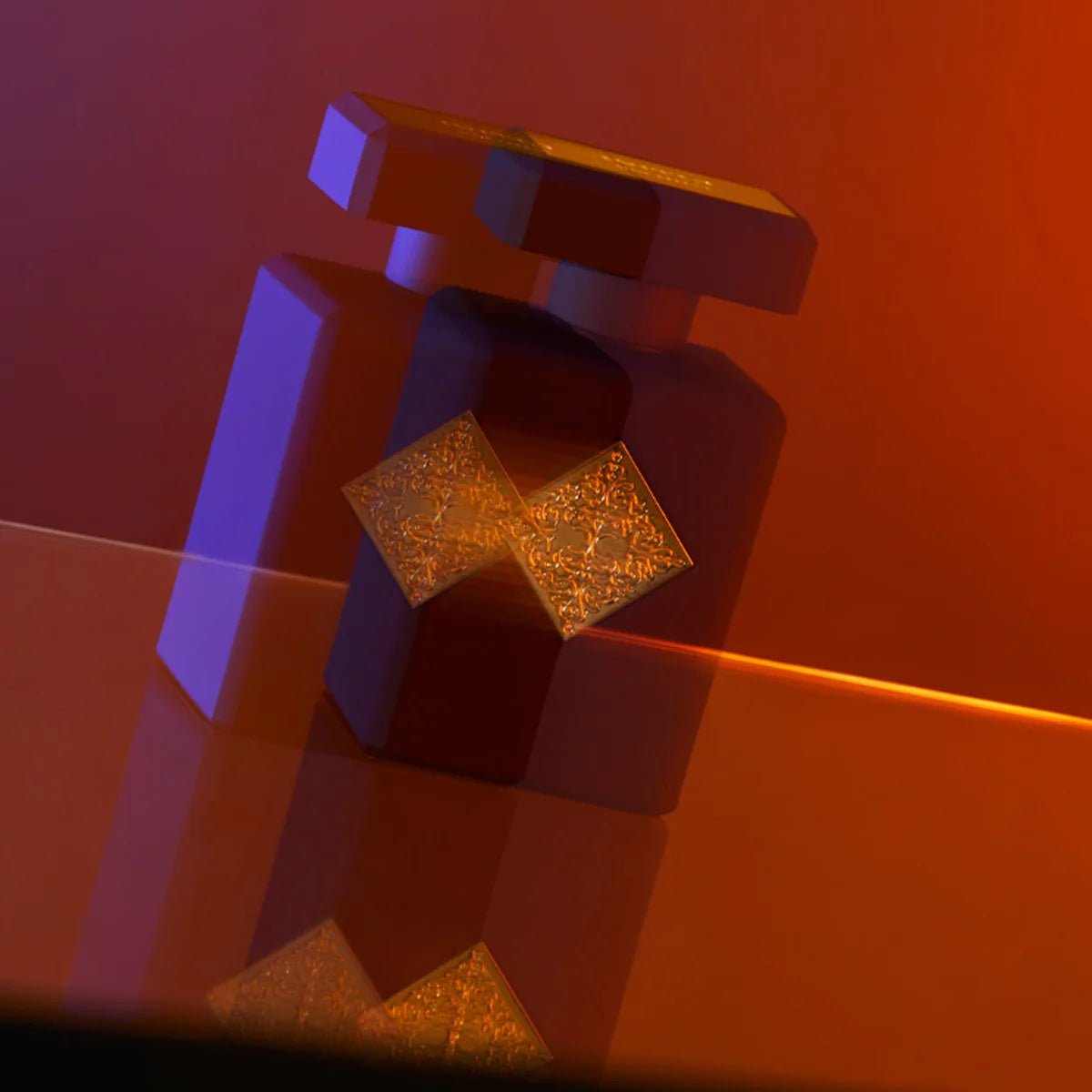 Gold square earrings on a reflective surface with a red-orange background