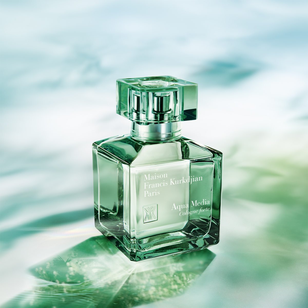 Green perfume bottle with Maison Francis Kurkdjian branding on a water-like background
