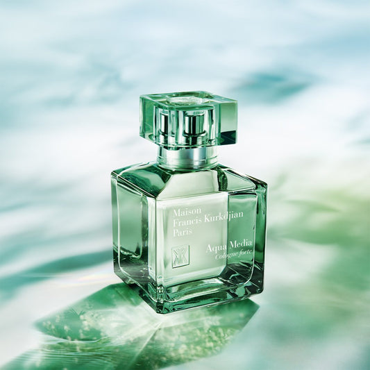 Green perfume bottle with Maison Francis Kurkdjian branding on a water-like background