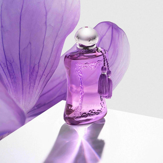 Purple perfume bottle with a tassel on a white background