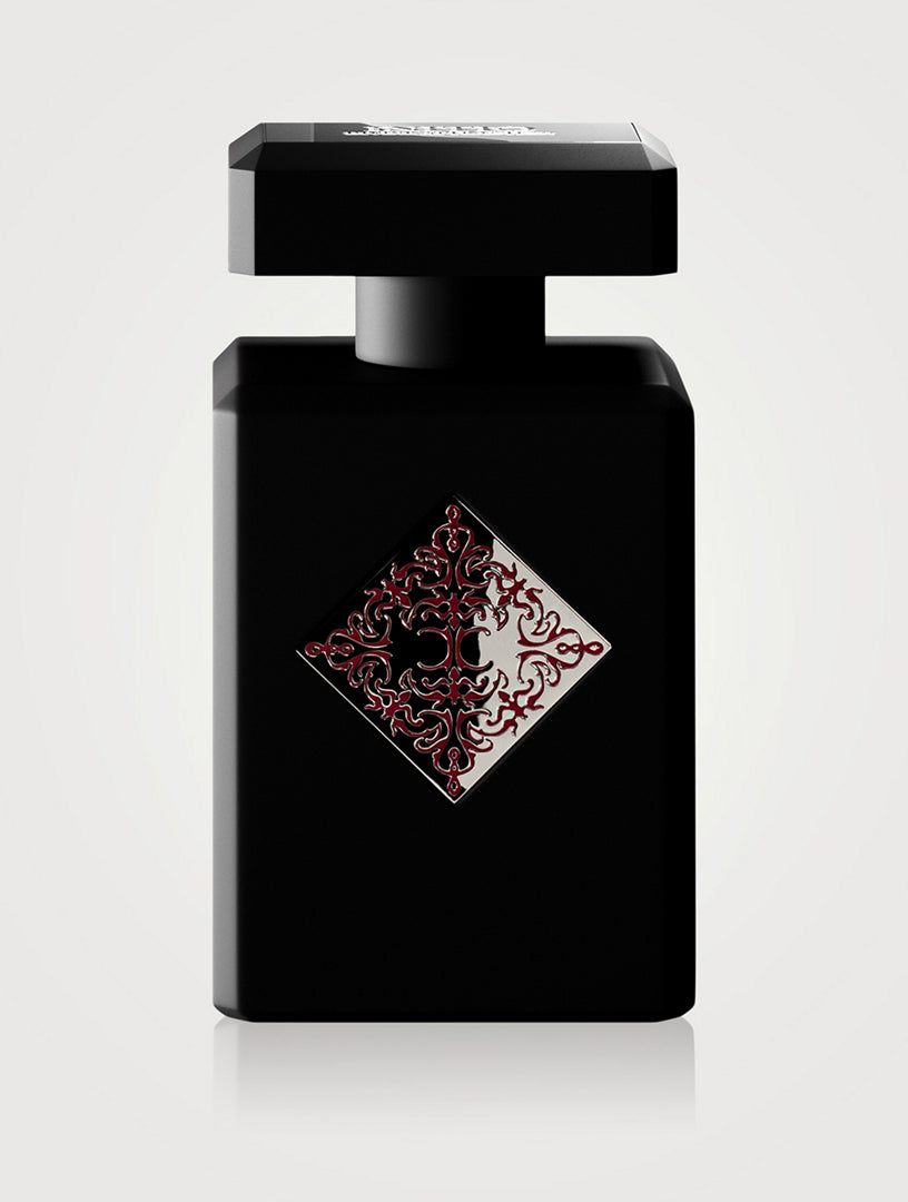 Black perfume bottle with decorative design on a white background